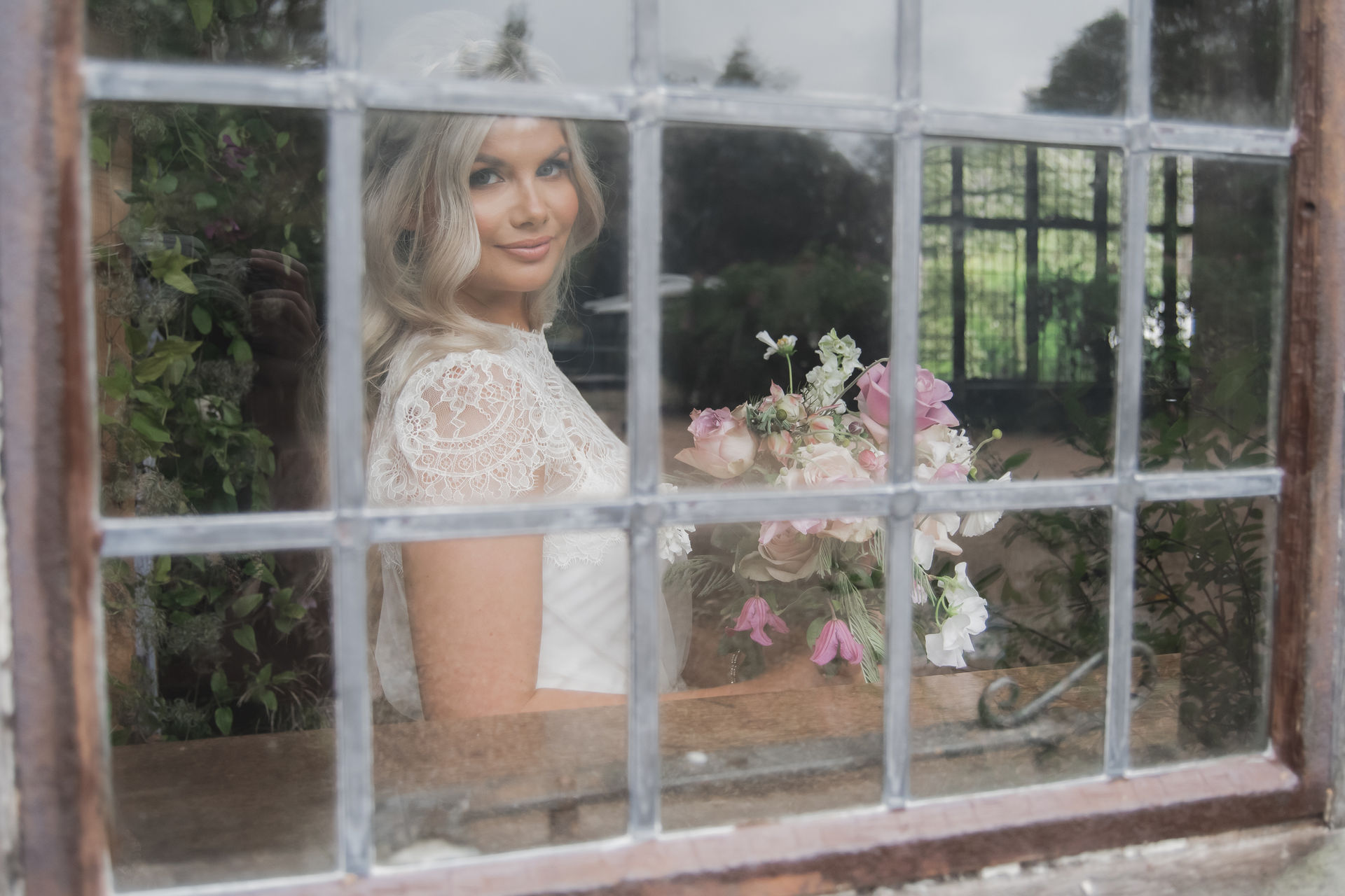 Bride looking out of a window.