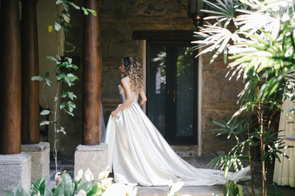 A bride in her wedding dress walking towards her first look with the groom in Pensativo House Hotel in Antigua Guatemala, ideal venue for an intimate luxury wedding in Guatemala.