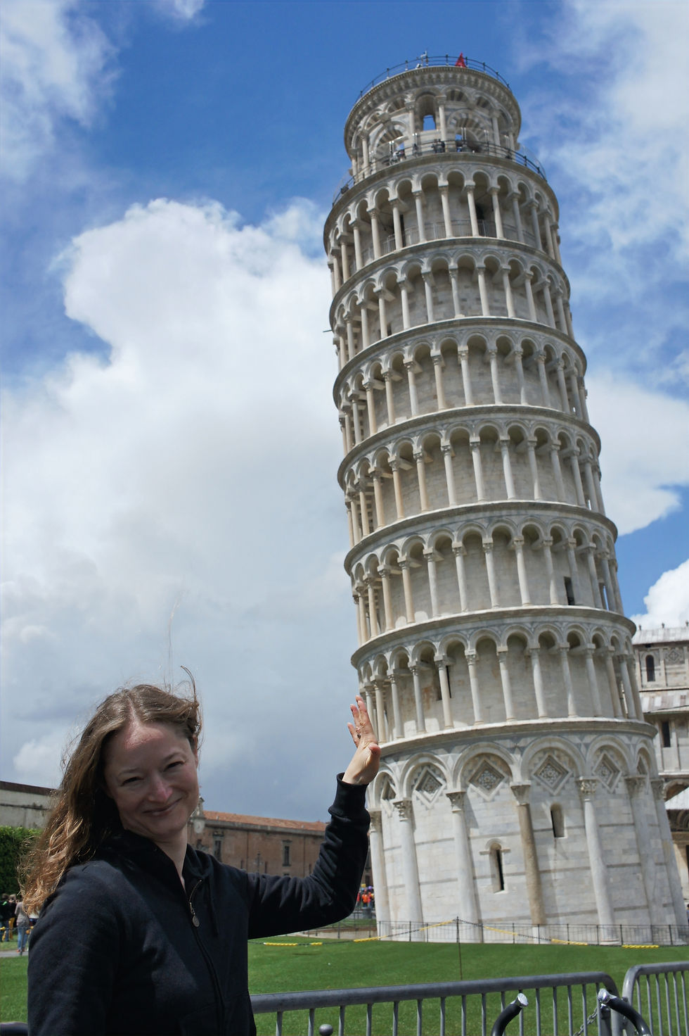 Optical illusion of woman holding up the Leaning Tower of Pisa