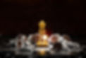 gold queen chess surrounded by a number of fallen silver chess pieces and abstraction conn