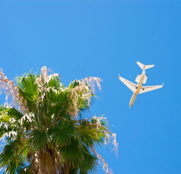 Private jet soaring above the clouds at high speed.