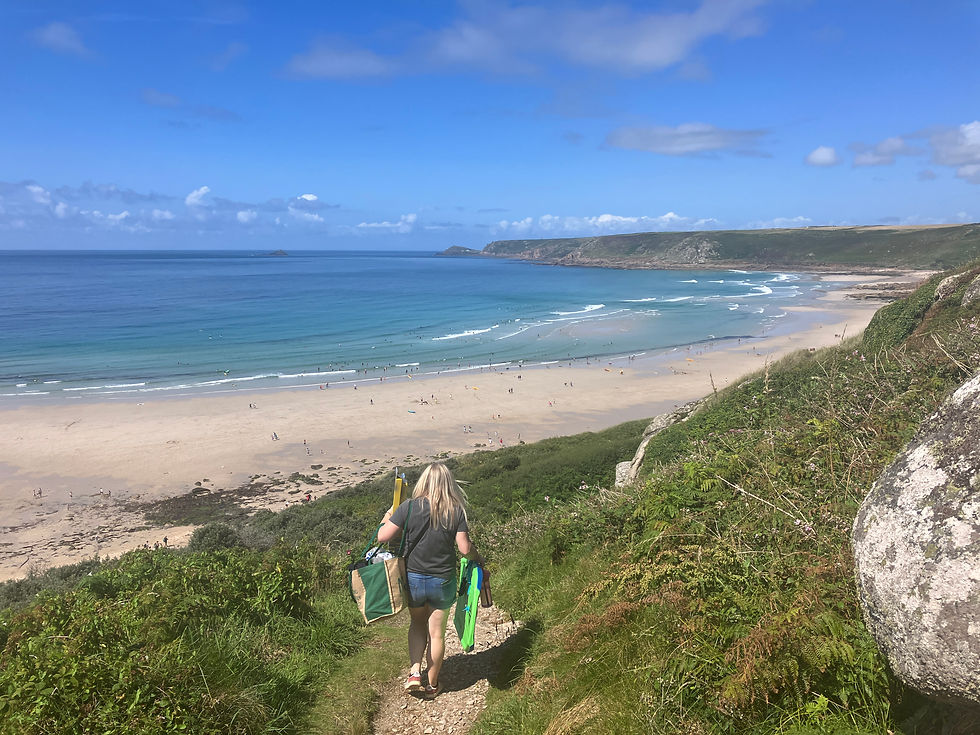 Woman walking down to Sennon Beach