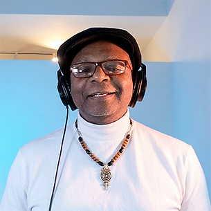 Close-up of man wearing headphones and glasses, smiling.