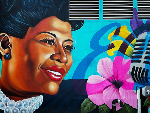 Mural of Ella Fitzgerald with microphone and flowers.