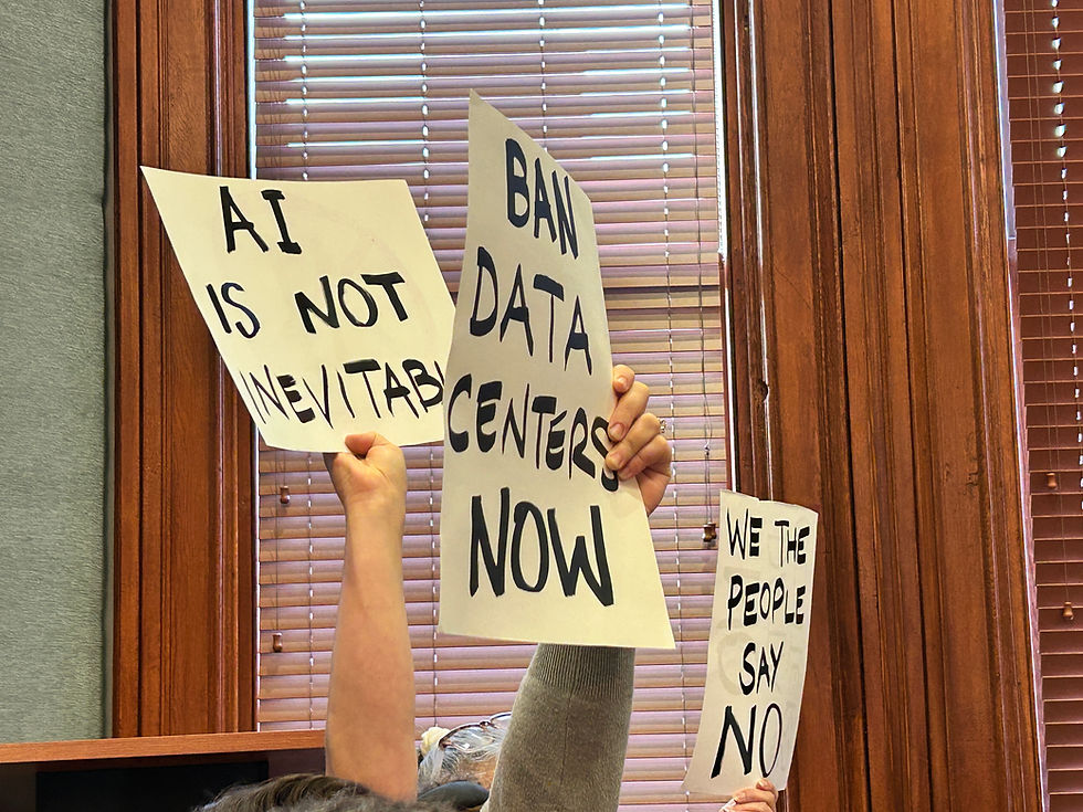 Residents holding up signs against the use of AI and data centers.