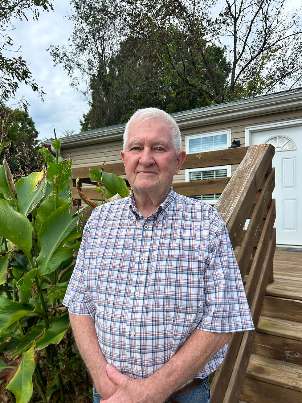 James "Jim"Taylor in front of one of the transitional homes for veterans