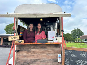 Rebecca and Nevaeh inside of Becky's Brews coffee trailer