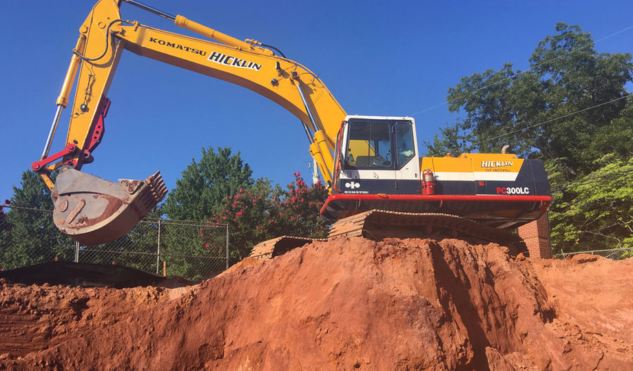 Excavator digging a hole