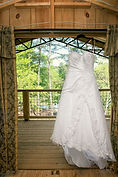 A wedding dress hanging in the doorway
