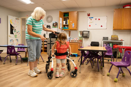 child with assistive walking device