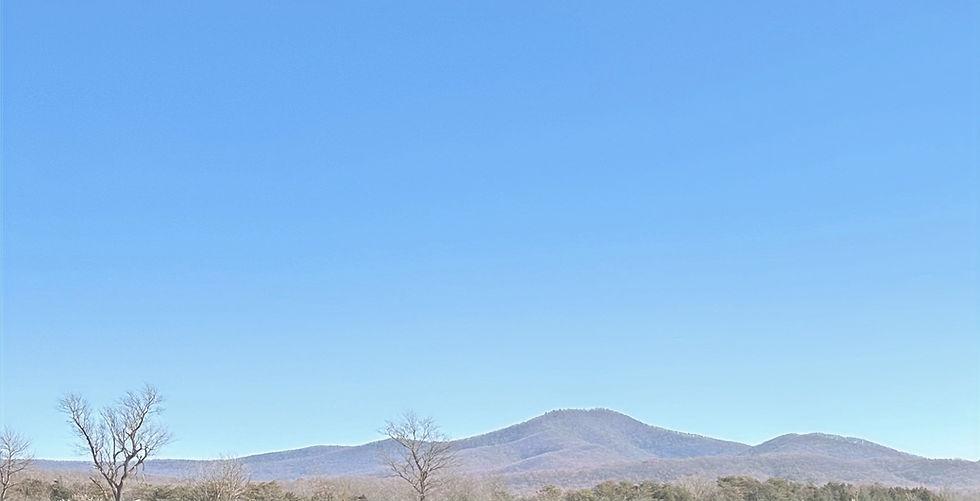 Rolling mountains against a bright blue sky