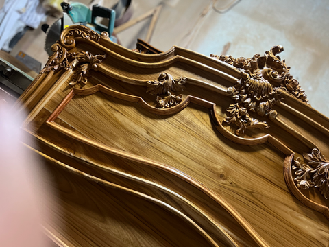 Hand-carved from solid teak, this bed showcases floral motifs and ornate details. Its rich grain and intricate carving highlight fine craftsmanship and timeless elegance.