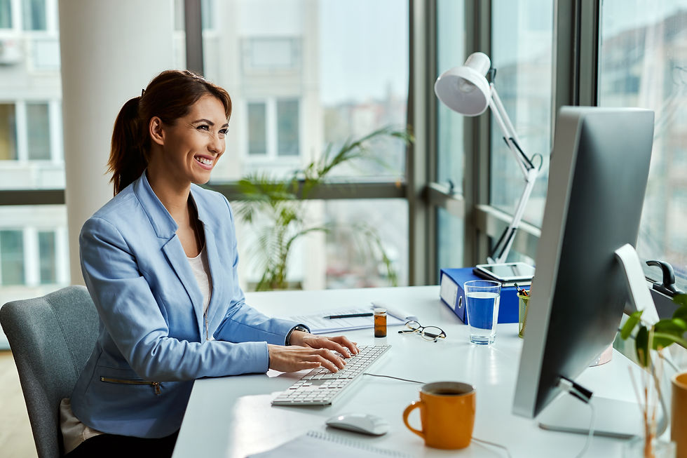 young-happy-businesswoman-using-desktop-pc-while-working-office.jpg