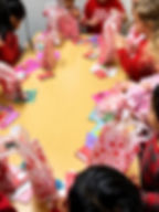Children exchange Valentine bags in preschool classrooms.