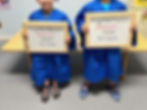 Two children graduating from Busy Bee preschool classrooms.