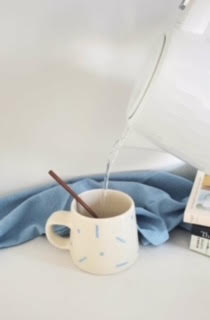 Pottery mug with blue confetti