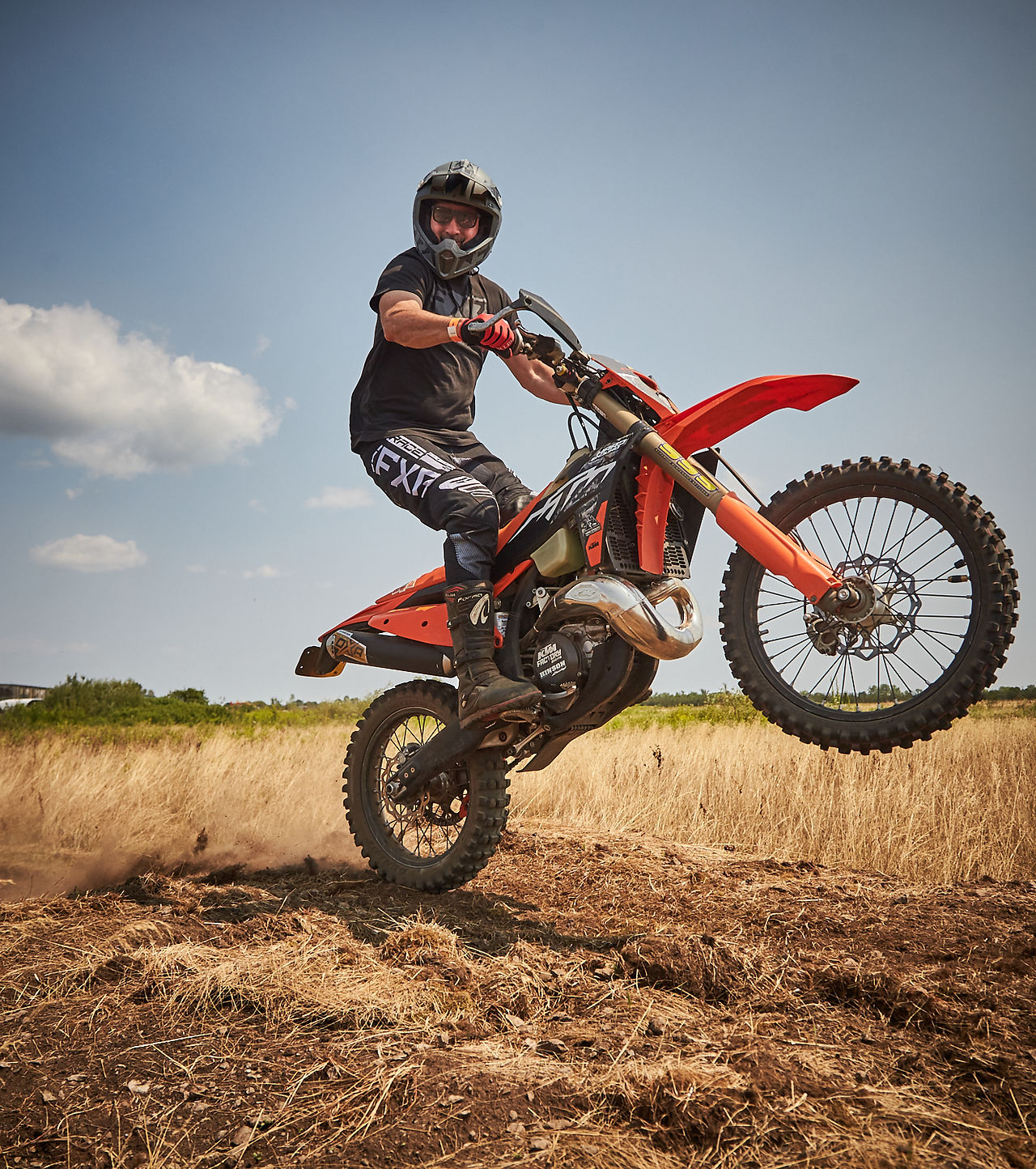Rider lifting the front wheel on a dirt bike during the TerreMX Experience at Moto Craft