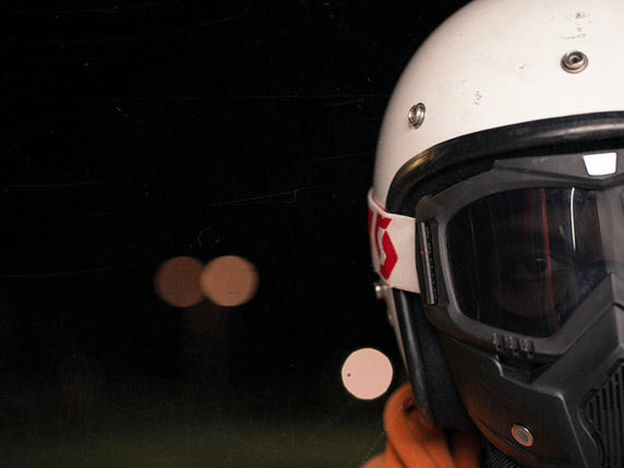A person wearing a motorcycle helmet and goggles