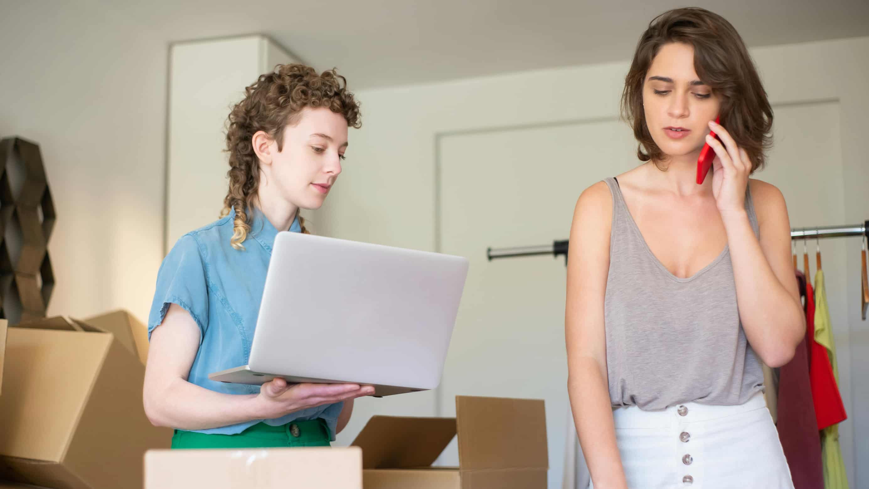 Two girls unpacking custom clothing