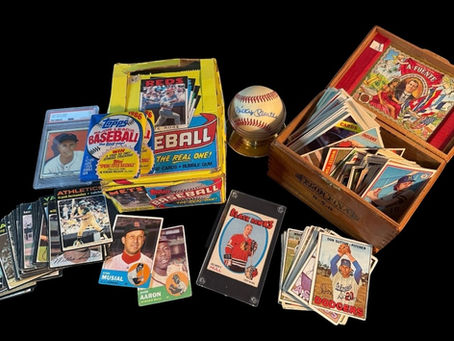 Vintage sports card collection with baseball cards, graded cards, and wax box on display
