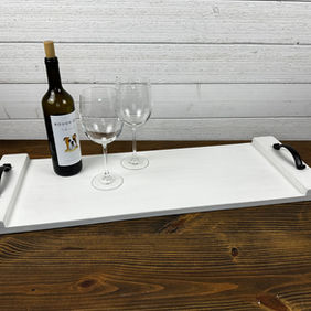 This classic and understated tray can be used as a decorative centerpiece, a bed or bath tray, and more. Featuring a timeless design, it is adorned with elegant metal handles for added charm and functionality.