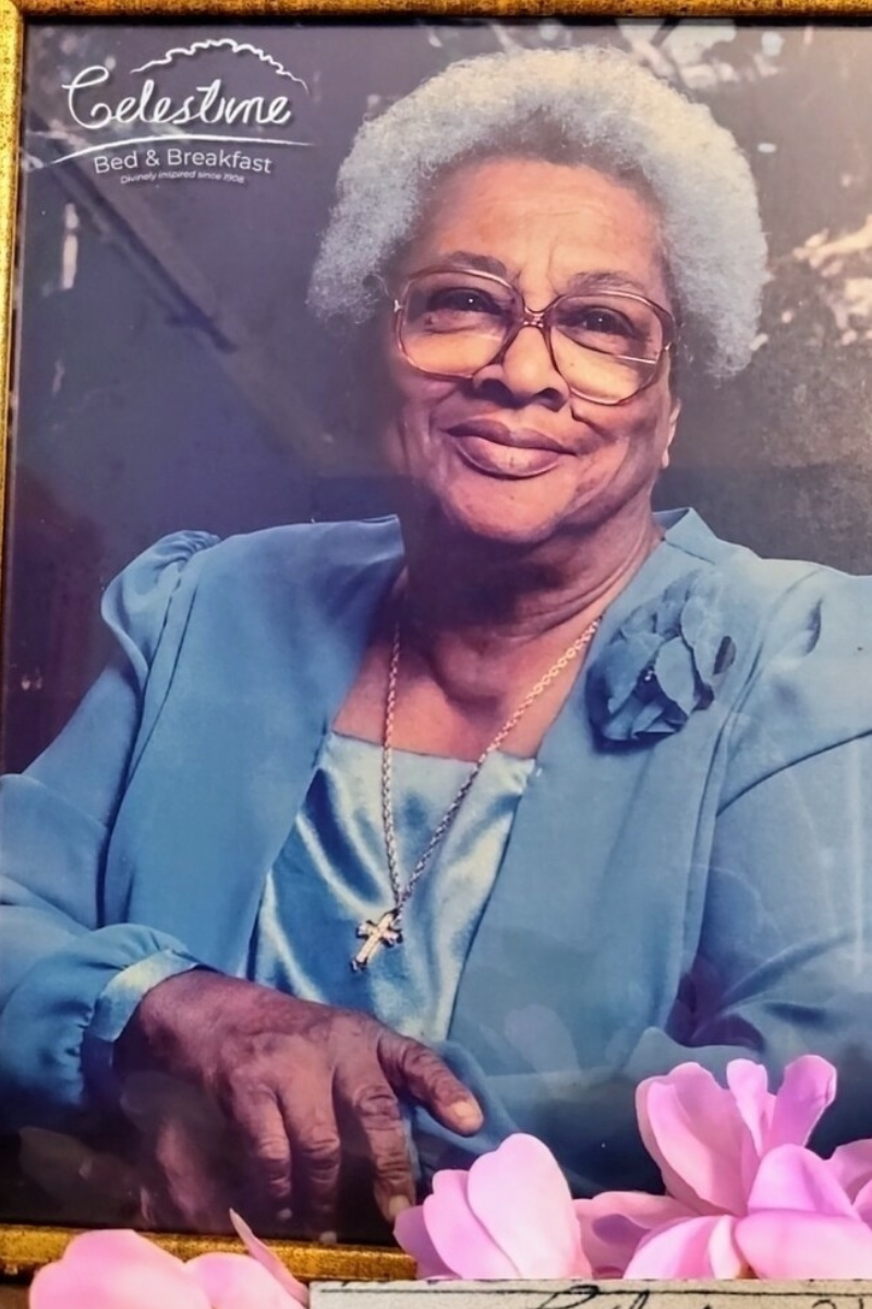 Framed vintage portrait of Celestine displayed among elegant décor, honoring the family legacy and history that inspire the bed and breakfast experience.