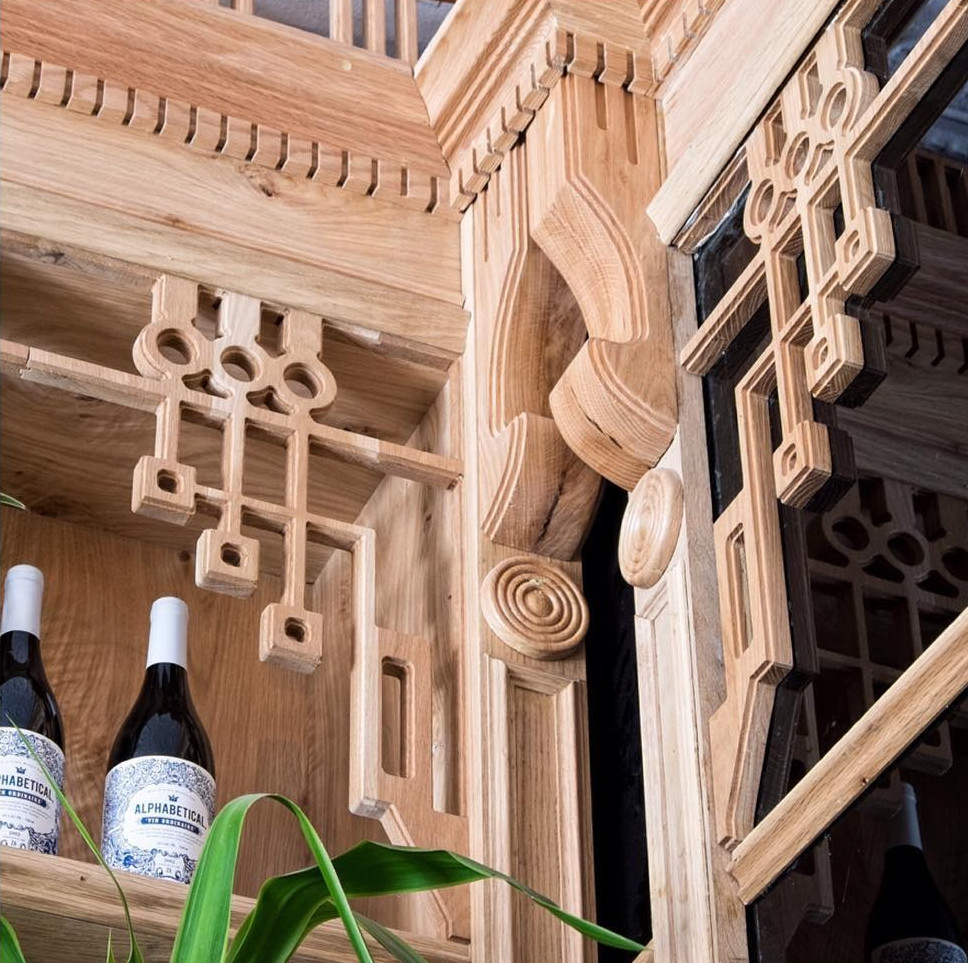 Detailed shot of The Sorrows joinery craftsmanship highlighting layered geometric timber carvings and corner detailing near a