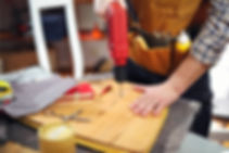 person drilling hole in wood