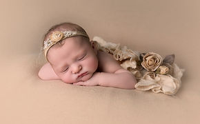 newborn girl sleeping in can on hands pose