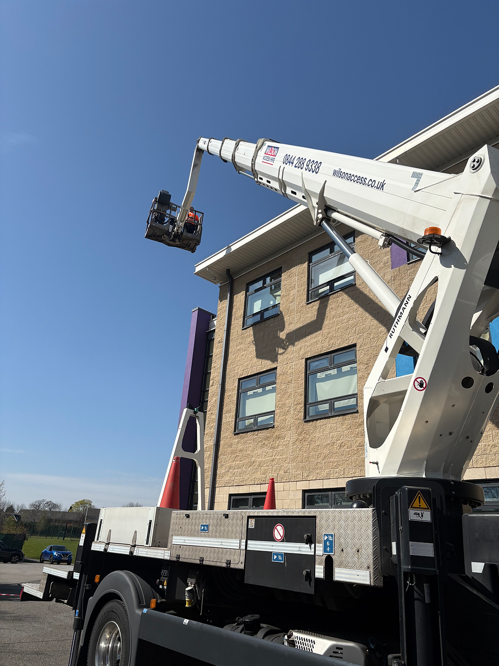 Cherry picker providing roofing services