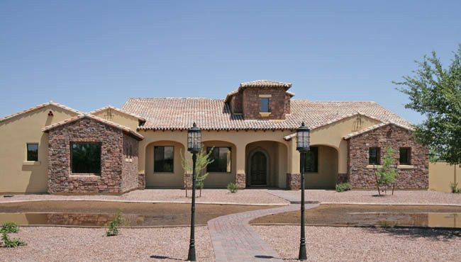 front of custom home with unique street lights in front of driveway