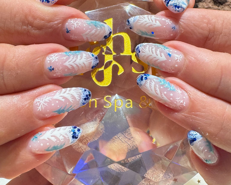 Winter nail art with snow-covered and green pine trees