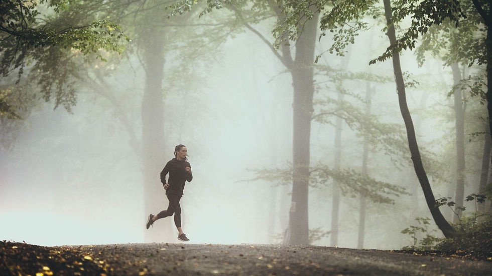 a woman jogging in foggy forest