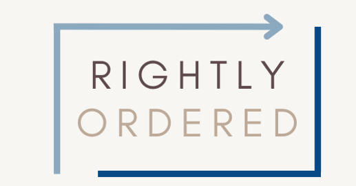 This is the logo for Rightly Ordered with the words of the business in the middle in two colors of brown and a box around the words in two colors of blue, one line being an arrow that points to the right.