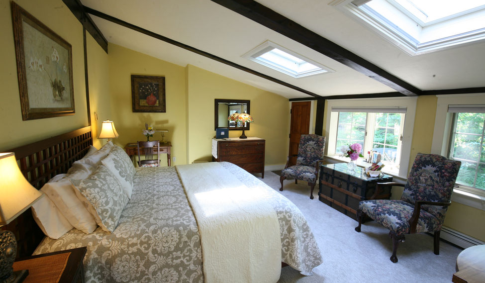 The interior of the Heron Room guest room showing the king sized bed at Morning Glory Inn bed and breakfast in York, Maine.