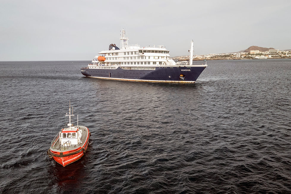 This aerial view shows a boat heading towards the port from the cruise ship MV Hondius, stationary off the port of Praia, the capital of Cape Verde, on May 6, 2026. (AFP/Getty Images/TNS)