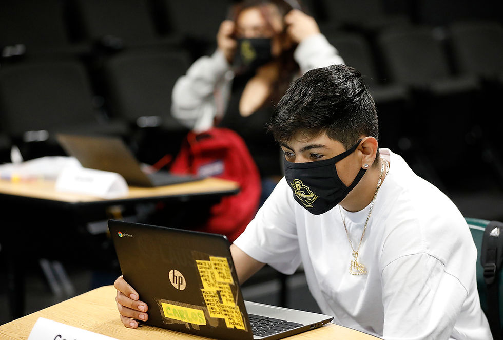 A ninth grader logs in via Zoom to classes in another part of the building as he sits in a Panorama High School classroom. (Al Seib/Los Angeles Times/TNS)