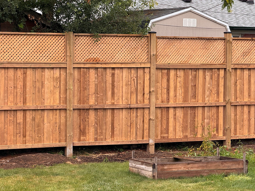 This wood fence combines full privacy at the base with a decorative lattice top for added style and openness. The solid lower section blocks visibility, while the lattice allows light and airflow, giving the fence a lighter, finished look. Built with strong posts and clean framing, it’s a great option for adding privacy without making the space feel closed in.