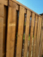 This semi-privacy wood fence features evenly spaced vertical boards that allow airflow and light while still providing a level of privacy. The design creates a balanced look—more open than full privacy fencing, yet still defining the space clearly. Finished in natural wood, it’s a practical option for backyards where visibility and ventilation are preferred without fully exposing the area.