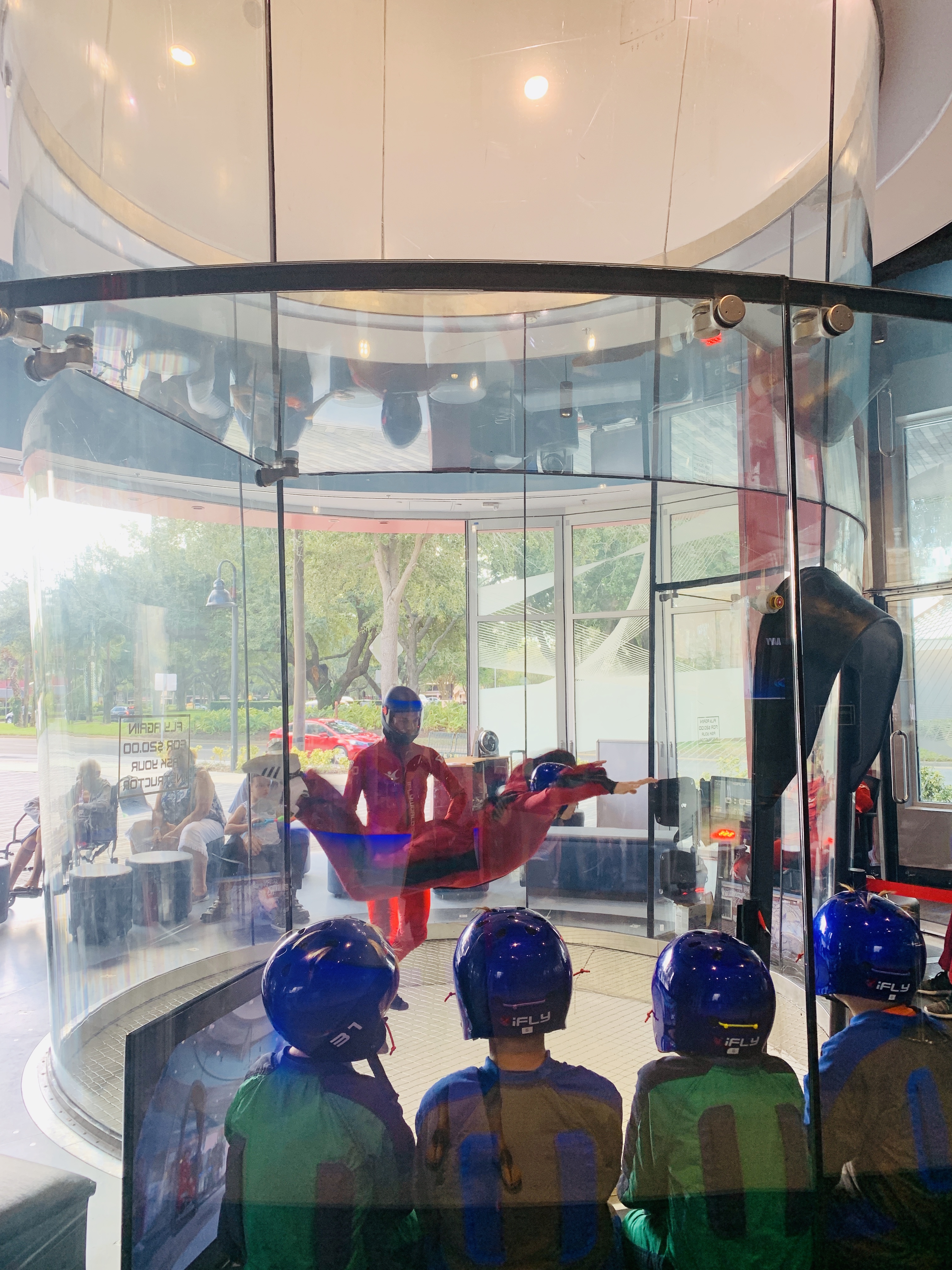 4 boys in blue helmets waiting there turn to indoor skydive at iFly Olando

