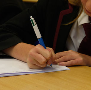 A pupil writing during a lesson