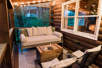 cabin porch sitting area dusk w lights.jpg