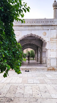 In Bagh-e Babur, or the Garden of Babur, a man begins his evening prayer under fancy archways in a small marble mosque.