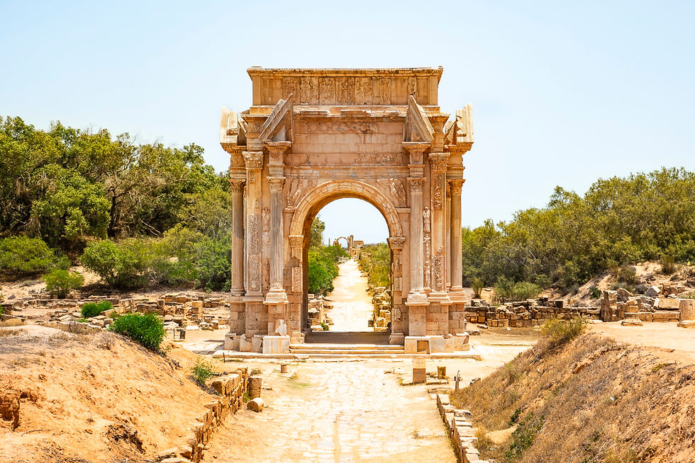 The austere and partially reconstructed Arch of Septimius Severus at the entrance to Leptis Magna on the Mediterranean Sea in Libya.