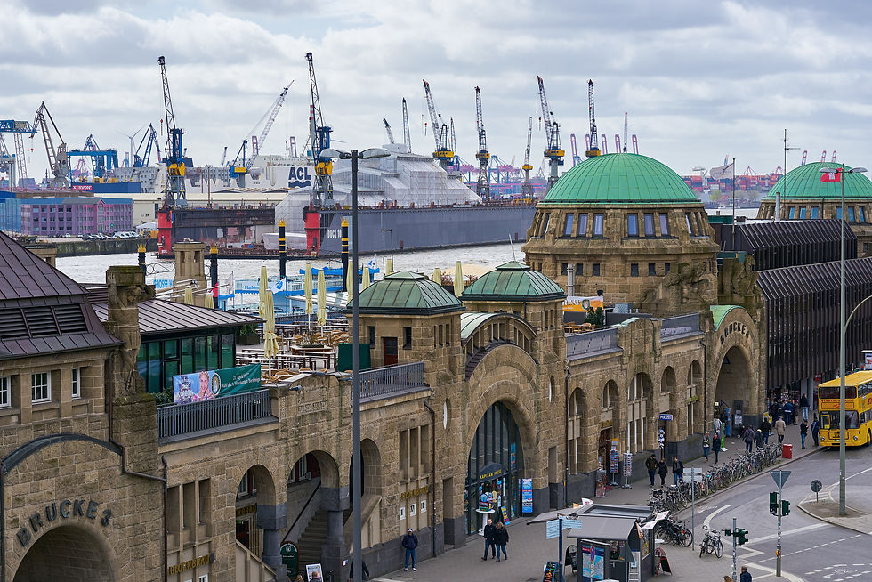 View of the Landungsbrücken in St. Pauli in Hamburg, with the port cranes in the background.