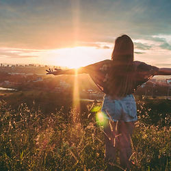 woman standing tall, arms outstretched accepting her healing