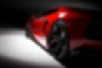 Red fast sports car in spotlight, black background. Shiny, new, luxurious. 3D rendering.jpg