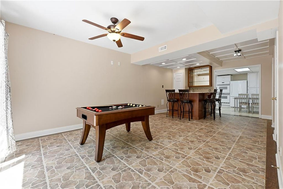 Finished basement with game area, wet bar, and second kitchen