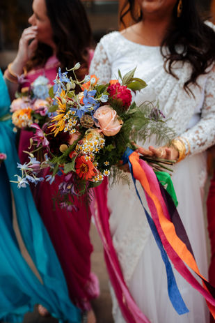 Vibrant wedding bouquet with rainbow ribbons