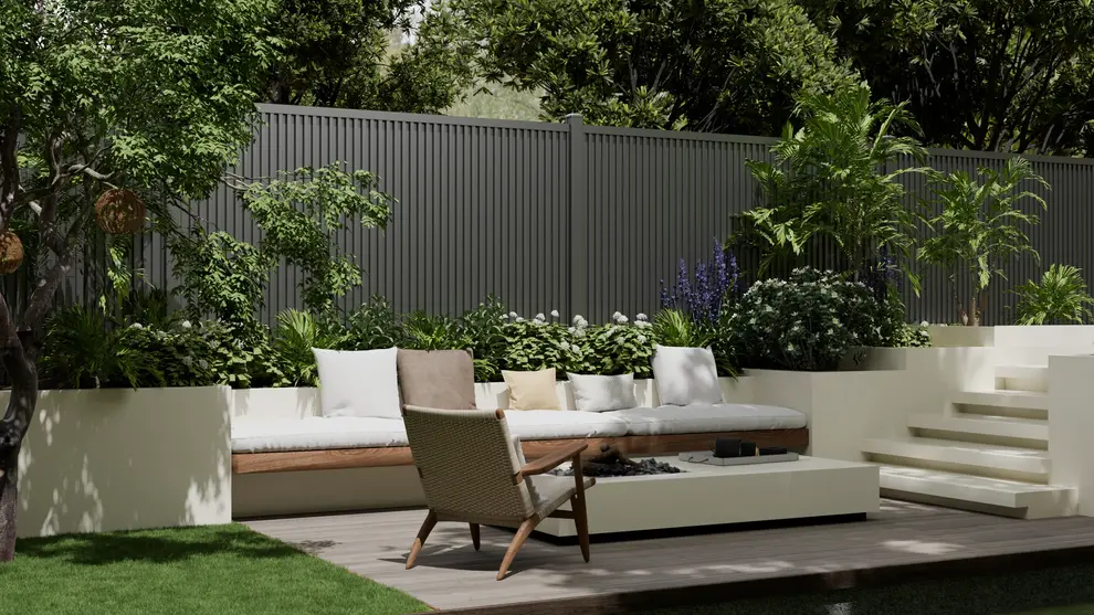 Vertical metal fence surrounding a landscaped backyard seating area